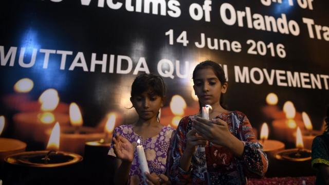 Pakistani young supporters of Muttahida Qaumi Movement (MQM) light candles in Karachi on June 14, 2016, to pay tribute for the victims of the Orlando shooting in Florida