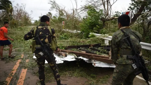 Rescue workers clear debris from road