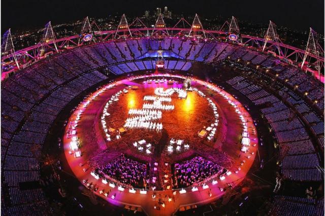 Performers pay tribute to the National Health Service (spelling out NHS) during the Opening Ceremony of the London 2012 Olympic Games