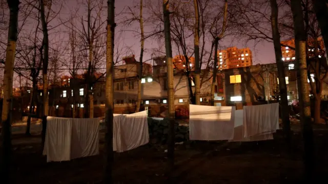 Edificios uno al lado de otro y con las luces encendidas.