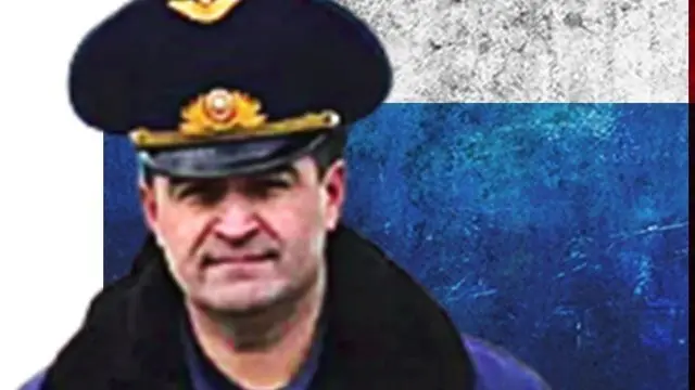 Image of deceased Russian general Kanamat Botashev over a treatment of the Russian flag