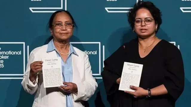 Banu Mushtaq (left) and Deepa Bhasthi (right) hold copies of Heart Lamp