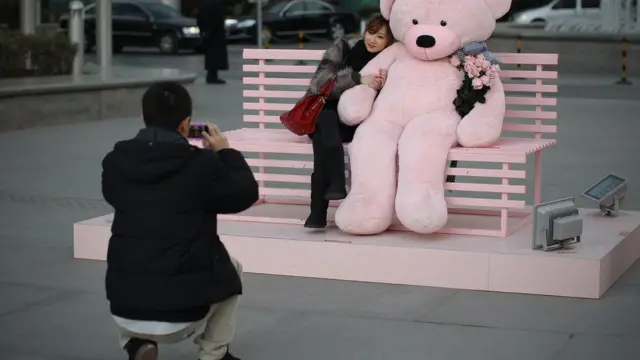 男子帮女子在装饰前拍照