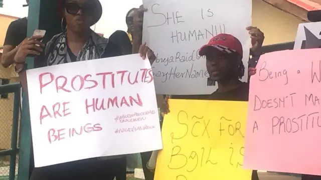 Women carry placards