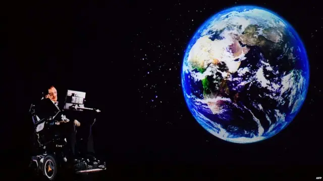 In this file photo taken on March 24, 2017, renowned physicist Stephen Hawking, 75, speaks to an audience by hologram (L) in Hong Kong, beamed live from his office in Cambridge, England.