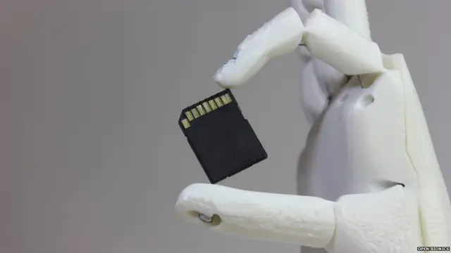 Ada holding a memory card