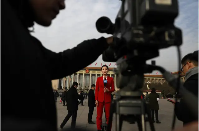 A Chinese TV journalist makes her report in Tiananmen Square during the opening of the first session of the 13th National People"s Congress (NPC) at the Great Hall of the People in Beijing, China, 05 March 2018. The NPC has over 3,000 delegates and is the world"s largest parliament or legislative assembly though its function is largely as a formal seal of approval for the policies fixed by the leaders of the Chinese Communist Party. The NPC runs alongside the annual plenary meetings of the Chinese People"s Political Consultative Conference (CPPCC), together known as "Lianghui" or "Two Meetings. EPA/HOW HWEE YOUNG EPA-EFE/HOW HWEE YOUNG