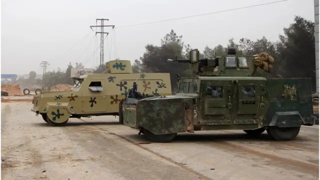 A rebel fighter from the Jaish al-Fatah (or Army of Conquest) brigades sits in a US-made Humvee (R) captured from the Iraqi army during a major assault on Syrian government forces West of Aleppo city on October 28, 2016.