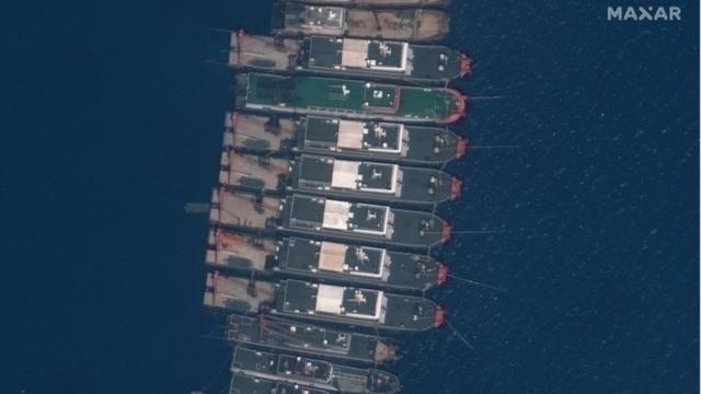 A handout satellite image made available by MAXAR Technologies shows Chinese vessels anchored at the Whitsun Reef in the disputed South China Sea on 23 March 2021 (issued 25 March 2021)