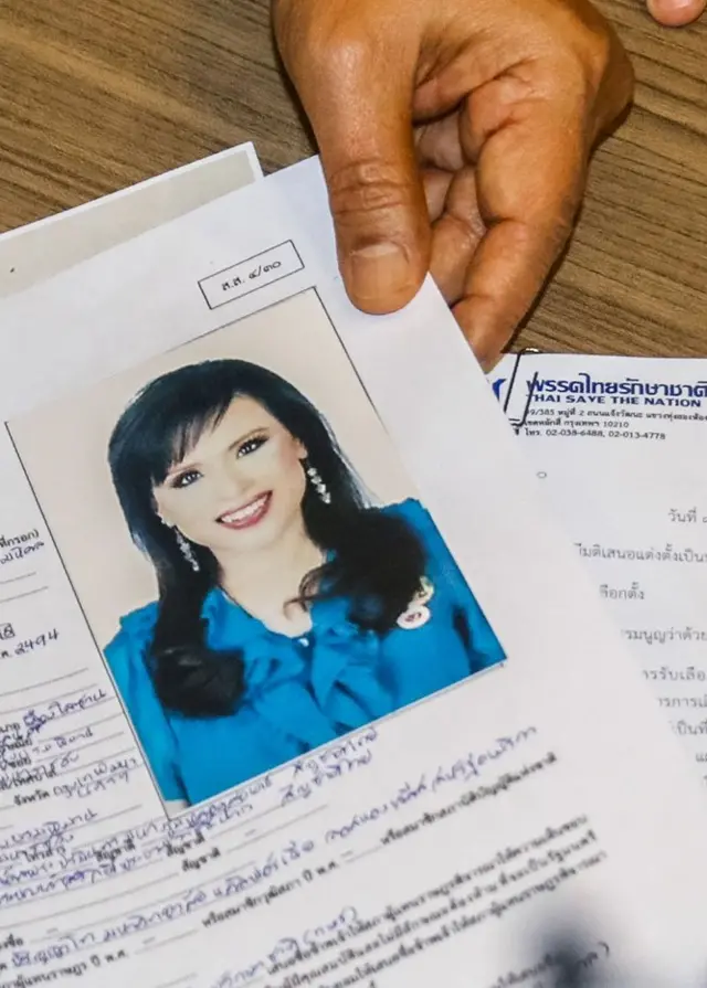 An official of Raksa Chart party submitting the registration document of Thai Princess Ubolratana bearing her photograph to election commission officials in Bangkok on February 8, 2019