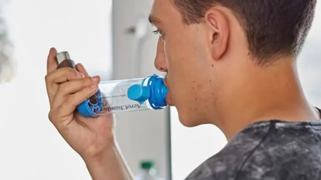 Man using an inhaler