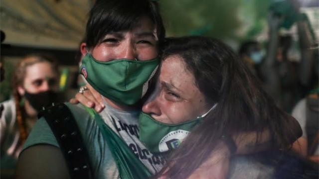 Mulheres emocionadas após aprovação da legalização do aborto no Senado argentino