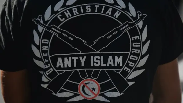 An anti-LGBT protester wears a t-shirt saying 'Anti-Islam, defend Christian Europe' in Poland, August 2020