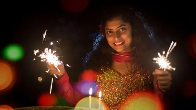 ਫੁੱਲਝੜੀ ਚਲਾ ਰਹੀ ਔਰਤ 