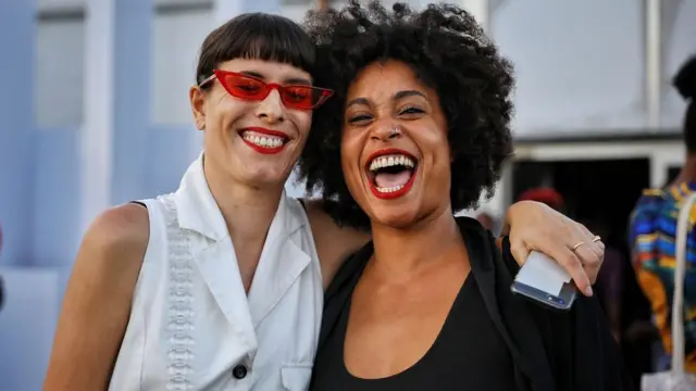 Two friends wey dey laugh