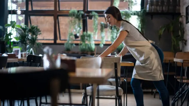 woman cleaning tables