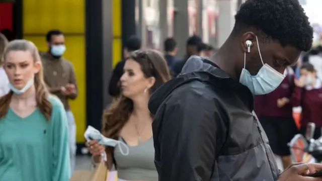 People on Oxford Street wearing face coverings