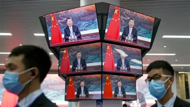 China"s President Xi Jinping is seen on screens in the media center as he speaks at the opening ceremony of the third China International Import Expo (CIIE) in Shanghai, China November 4, 2020