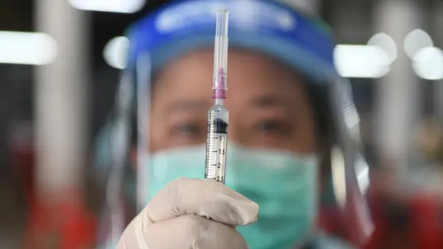 Nurse holds syringe