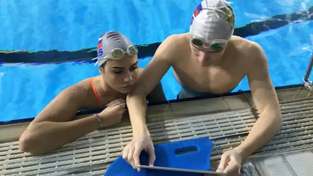 Саша Мальцев и Майя Гурбанбердиева просмотривают запись тренировки на планшете