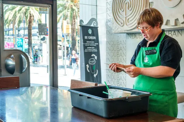 Down's syndrome employee at a Starbucks coffee shop in Barcelona, Spain (2019 picture)