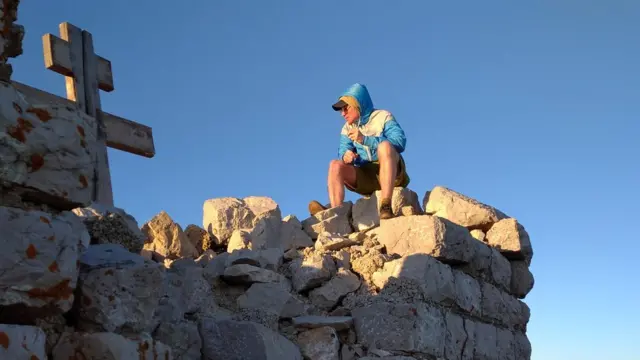 Goran Lončarević sedi na ruševinama kapele na vrhu Rtnja