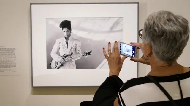 Una visitante mira una fotografía del músico Prince tomada por Lynn Goldsmith en 1993 en la Galería Nacional de Retratos del Smithsonians el 22 de abril de 2016, en Washington DC.