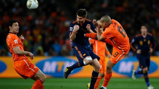 Nigel De Jong of the Netherlands tackles Xabi Alonso of Spain during the 2010 FIFA World Cup South Africa Final match between Netherlands and Spain at Soccer City Stadium on July 11, 2010 in Johannesburg, South Africa