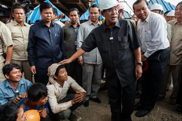 Cambodian Prime Minister Hun Sen visiting workers at a construction site.