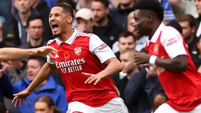 Arsenal's players celebrate scoring at Chelsea