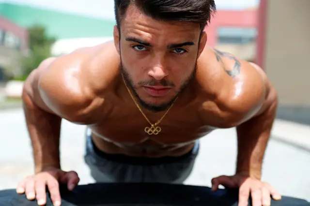 An athlete looks to the camera as he trains