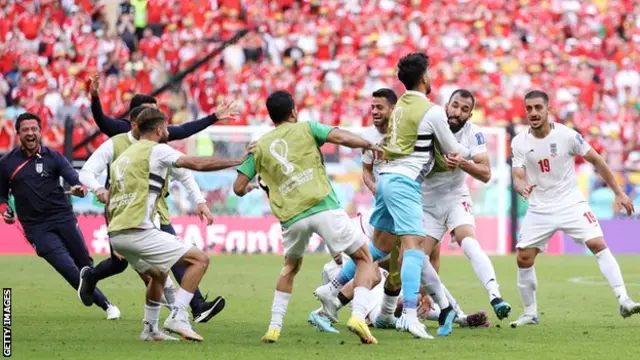 Iran celebrate Roozbeh Cheshmi's goal