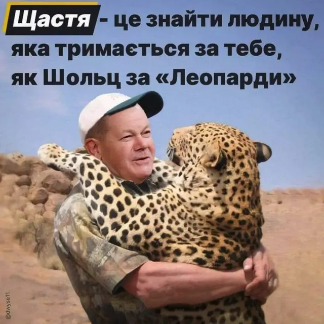 German chancellor Olaf Scholz hugging a leopard