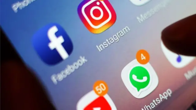 Social media icons displayed on a mobile phone