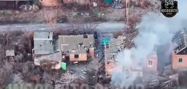 Дым среди домов после удара беспилотника