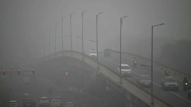 Commuters drive amid dense smog in New Delhi 