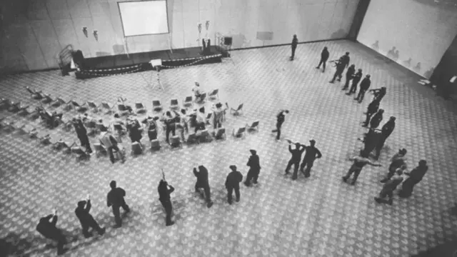 The fugitives were taken into a large hall in small groups, where they were surrounded by police