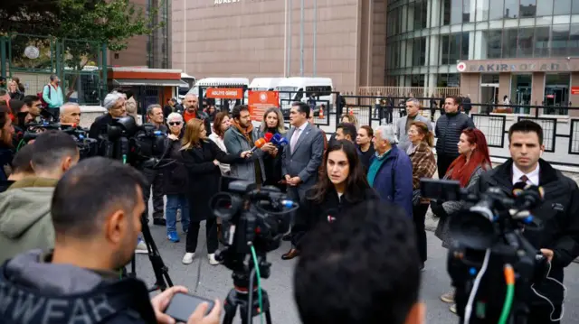 TV crews operate in front of the Bakirkoy courthouse, on the opening day of Turkey's "newborn gang trafficking" case trial in Istanbul
