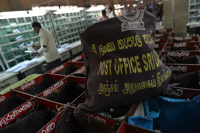 Sri Lankan postal service's employees work at the General Post Office in Colombo on October 3, 2013. 