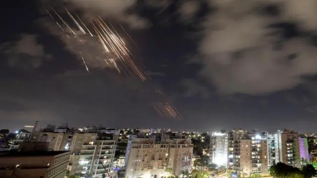 Israel's Iron Dome anti-missile system intercepts rockets in the dark skies over the city of Ashkelon