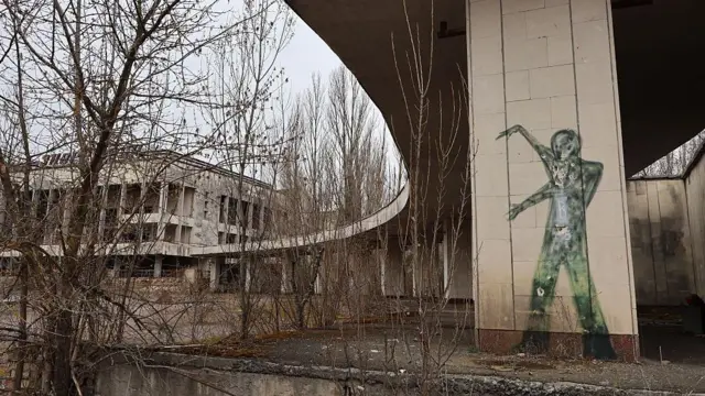 Grafites no Palácio da Cultura Enerhetyk, abandonado na praça central de Prypiat, no oblast de Kiev, na Ucrânia, em 12 de abril de 2025