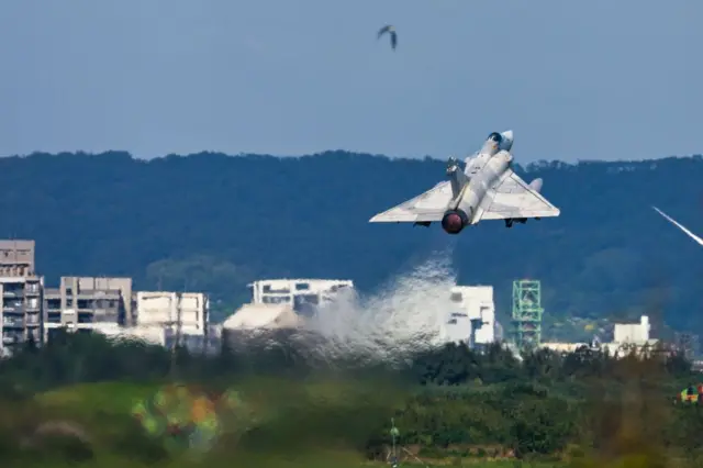 Avião de caça taiwanês decola com prédios residenciais ao fundo durante um exercício militar em uma base aérea em Hsinchu, Taiwan, em 7 de novembro de 2024