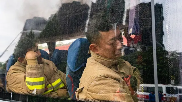 2025年11月27日，輪班消防員在現場稍作休息。 