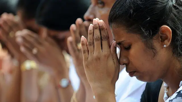श्रीलंकाई महिला प्रार्थना करते हुए 
