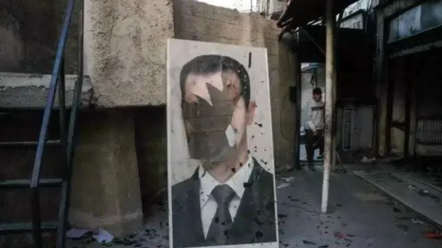 Сирія, пошкоджений портрет Асада 