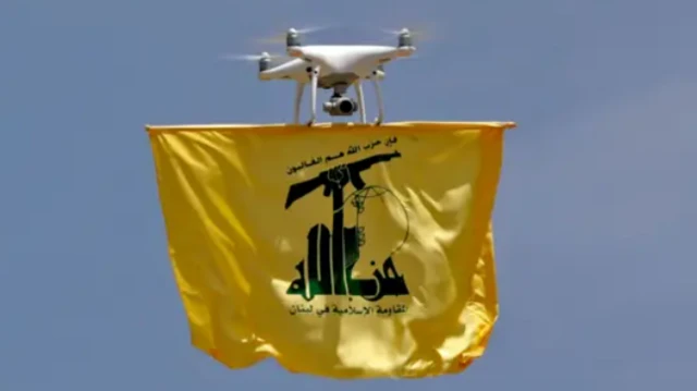 The Hezbollah flag being held in the air by a drone