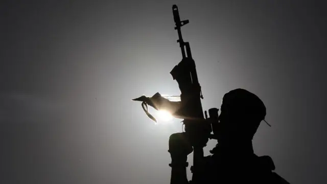 Gunman guards stage as Sinwar addresses rally in 2021