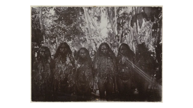 Sekelompok perempuan Papua berpakaian adat dalam foto hitam putih.