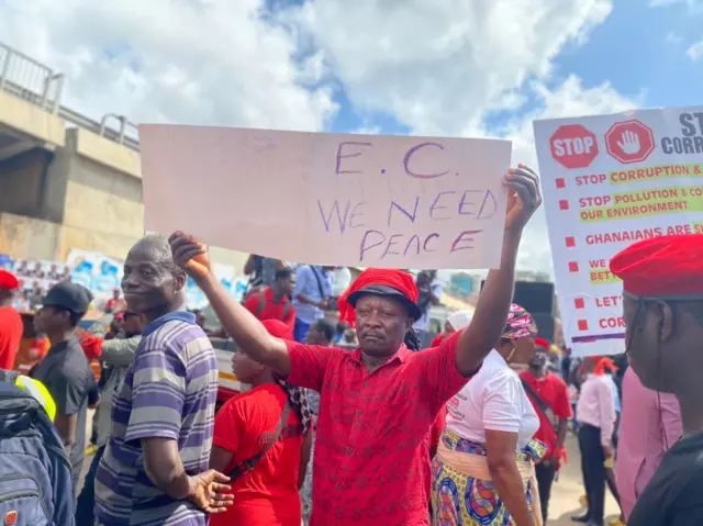 Protester carry placard for Ghana on 3 October