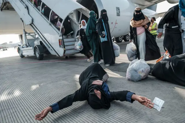 An Ethiopian woman repatriated from Saudi Arabia reacts as she disembarks from the airplane at the Bole Airport, in Addis Ababa, on March 30, 2022.